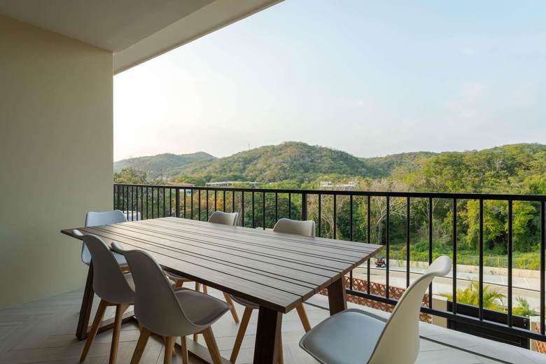 Balcony morning light — lush jungle treetops