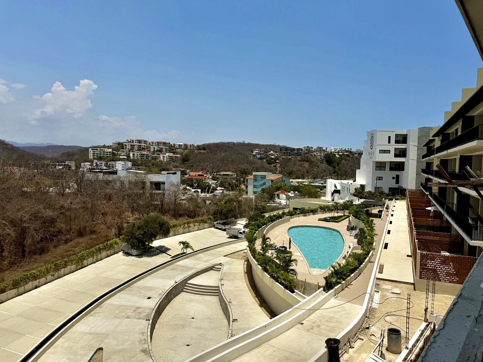 Casa Rico — view from balcony over Nirú pool and Santa Cruz hillside