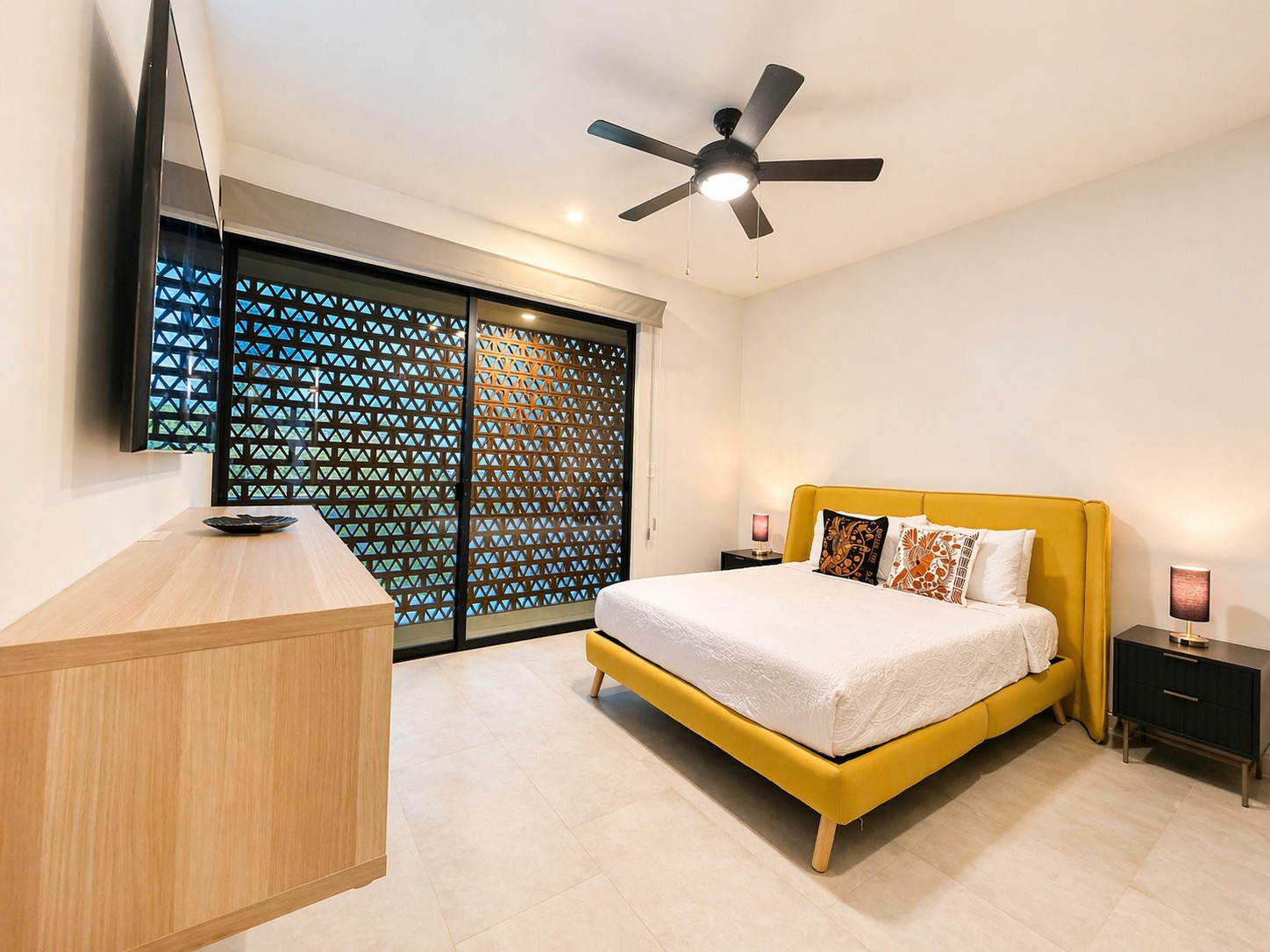 Second bedroom — mustard velvet bed and signature lattice screen doors