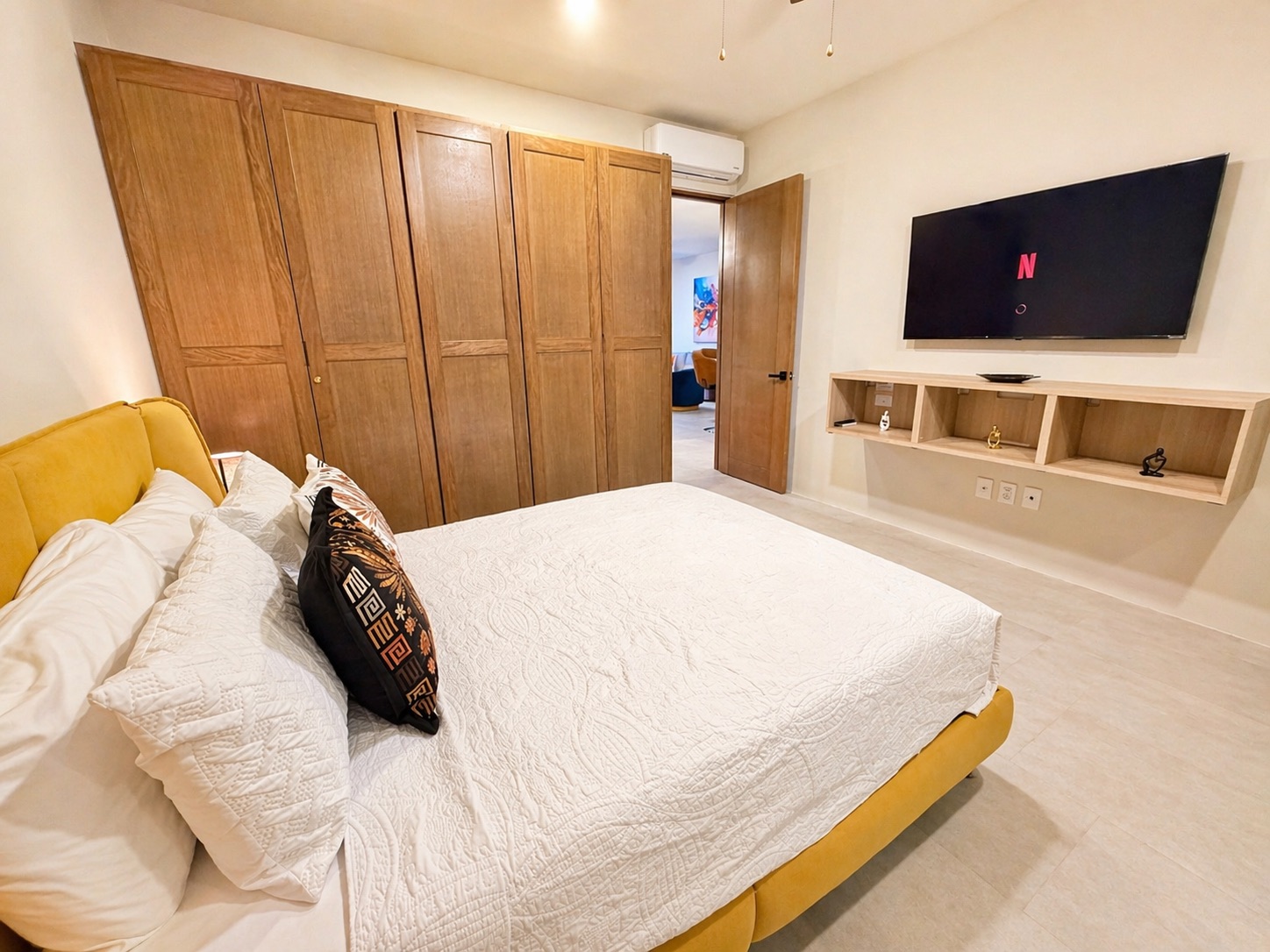 Second bedroom with built-in wardrobe storage and Smart TV