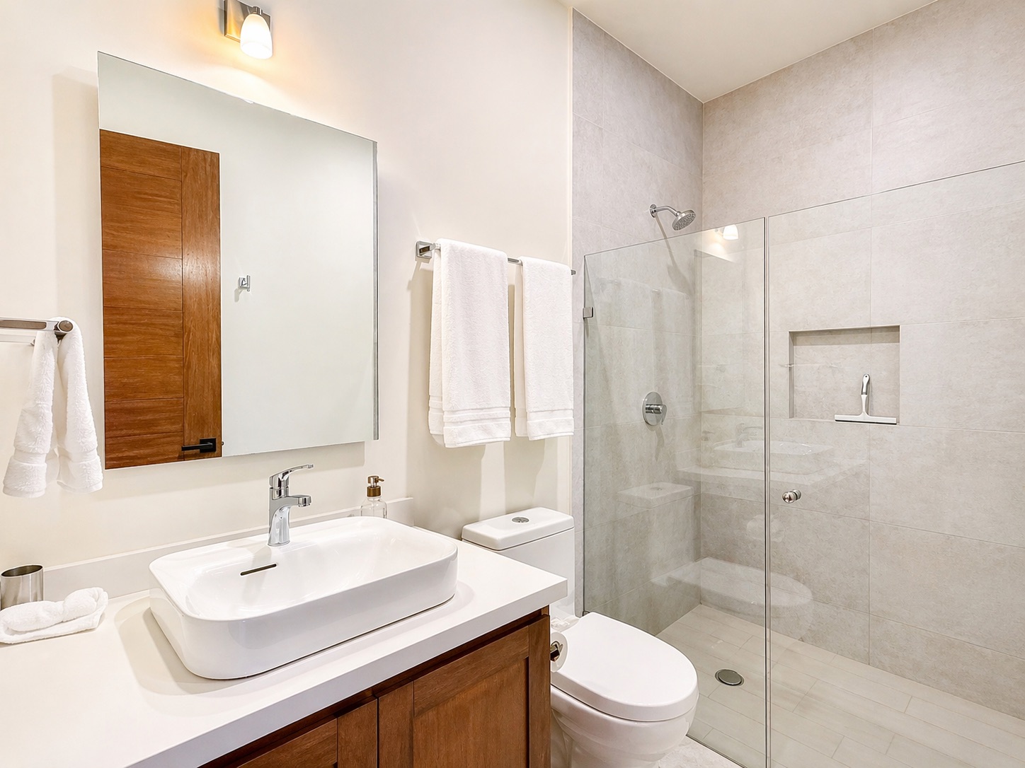 Second full bath — walk-in shower with niche and white quartz vanity